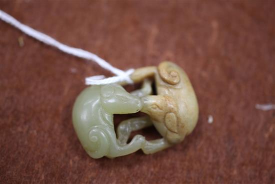 A small Chinese yellow and russet jade group of two hounds, 18th / 19th century, 3.7cm
